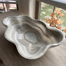 Load image into Gallery viewer, A polished and shine gray onyx stone bowl with natural patterns placed on a flat surface, likely used as a decorative centerpiece.
