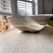 Load image into Gallery viewer, A polished and shine gray onyx stone bowl with natural patterns placed on a flat surface, likely used as a decorative centerpiece.
