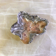 Load image into Gallery viewer, An elegant hand-carved stone bowl with capricious veins in beige and light brown tones, placed on a marble surface.
