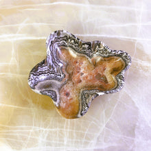 Load image into Gallery viewer, An elegant hand-carved stone bowl with capricious veins in beige and light brown tones, placed on a marble surface.
